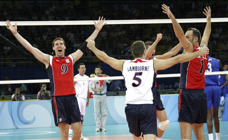 U.S. volleyball players Ryan Millar, left, Richard Lambourne, and Lloy Ball celebrate a win.