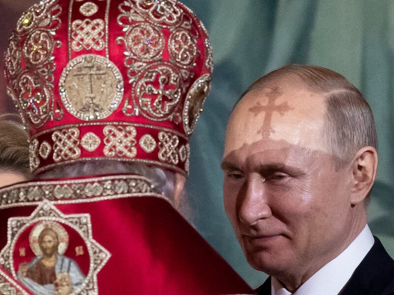 Russian Orthodox Patriarch Kirill, left, talks to President Vladimir Putin, right, during the Easter service in Moscow,
