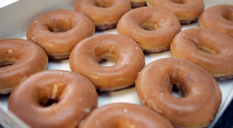 You can get a free dozen Krispy Kreme glazed doughnuts now until Jan 27 with the purchase of any dozen.