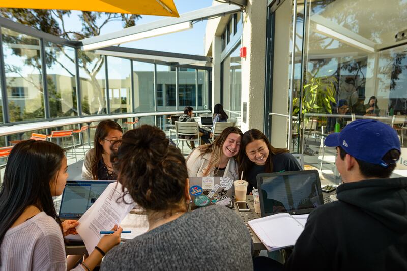 Members of the InterVarsity Graduate Christian Fellowship at the University of Iowa hang out on campus. The group has filed a lawsuit asserting that making changes to its club constitution would undermine its religious identity.