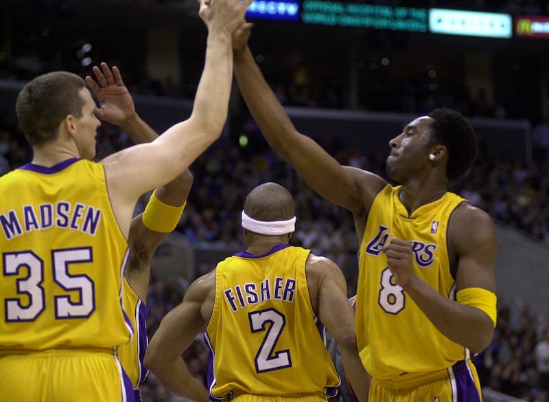 Mark Madsen congratulates Kobe Bryant after Bryant scored in a 2001 LA Lakers game. Madsen and Bryant were teammates for three years.