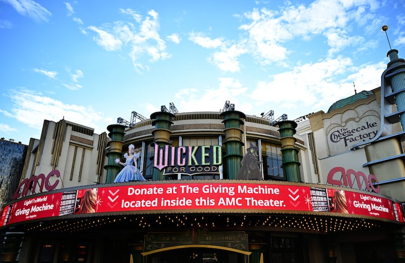 The Giving Machines and "Wicked: For Good" are simultaneously advertised outside the movie theater at The Grove in Los Angeles