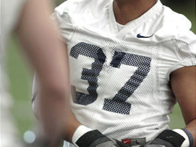 Vic So'oto stretches during BYU's second spring practice on Tuesday. The junior has moved from tight end to linebacker for BYU.