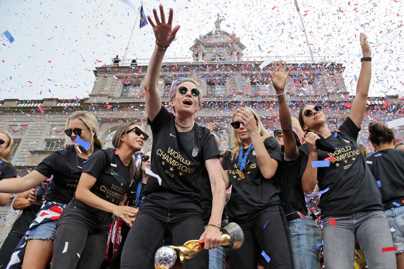 Megan Rapinoe and Alex Morgan celebrate with U.S. women’s soccer teammates.