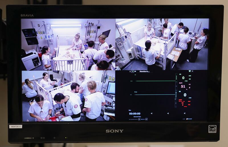 Sharifa Al-Qaaydeh, a clinical professor of nursing at the University of Utah, watches monitors as her nursing students work a simulated emergency with a cutting-edge baby simulator named Hal in Salt Lake City on Monday, July 30, 2018.