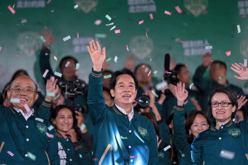 Taiwanese Vice President Lai Ching-te, also known as William Lai, left, celebrates his victory with running mate Bi-khim Hsiao in Taipei, Taiwan, on Jan. 13, 2024.