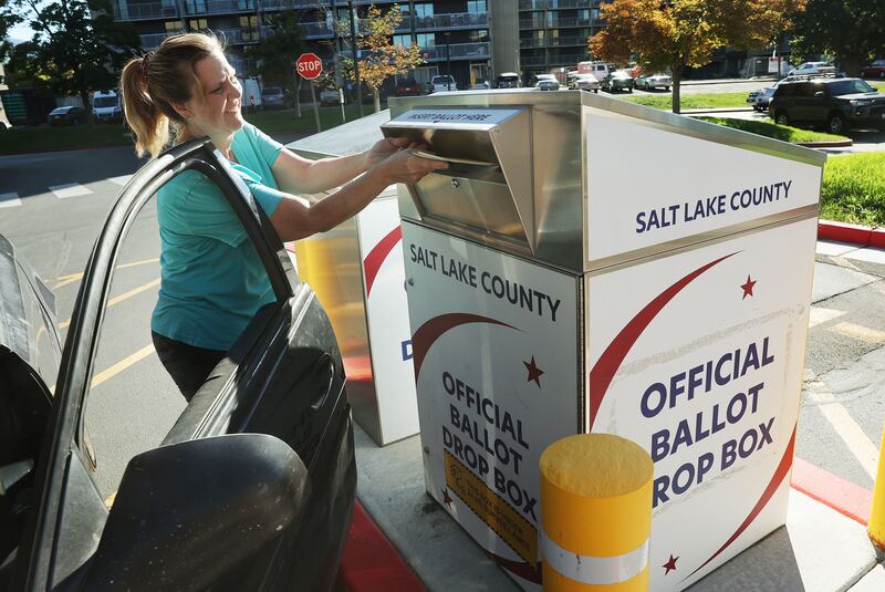 Tracy Ashcraft drops off her ballot during Utah’s municipal and primary elections, at the Salt Lake County Government Center.