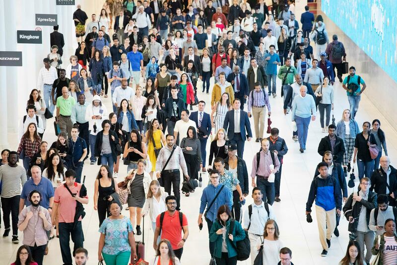 In this June 21, 2019, file photo commuters walk through a corridor in the World Trade Center Transportation Hub in New York. Millennial workers are more likely than older generations to report being burned out at work, according to a 2018 Gallup study. The gig economy, the temptations of social media and the high expectations millennials have of themselves contribute to this trend, behavioral finance experts say.