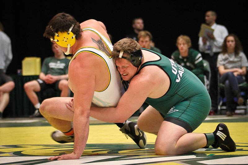 UVU heavyweight Adam Fager (right) pulls his opponent to the floor. Fager will wrestle at the NCAA Championships for the second time in his career.
