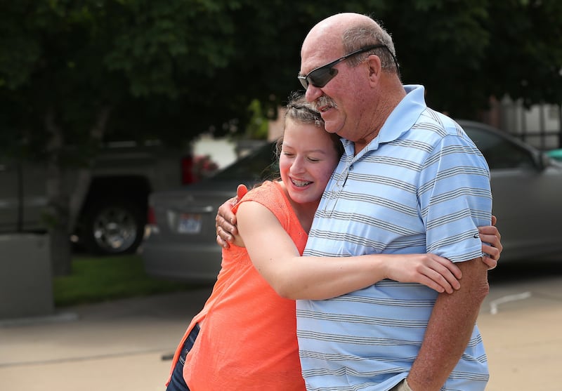 Morgan Selleneit hugs her grandfather Daniel Grover in Centerville on Thursday, May 31, 2018. Morgan is 15 and uses her phone around 3 hours a day, mostly on Instagram and Snapchat.