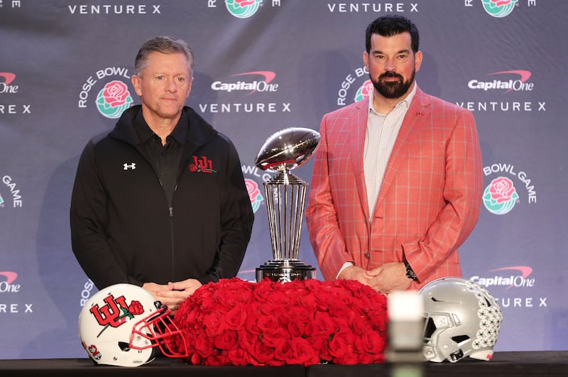 Utah Utes head coach Kyle Whittingham, left, and Ohio State Buckeyes head coach Ryan Day pose with the Rose Bowl trophy.