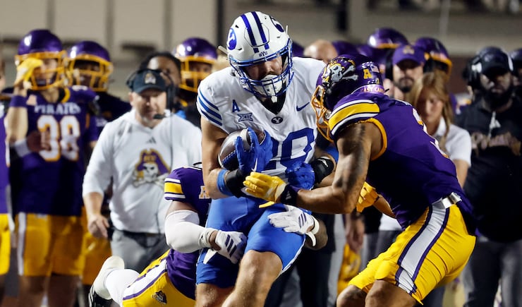 BYU tight end Carsen Ryan, front left, prepares to be hit by East Carolina's Teagan Wilk, front right, was called for targeting and ejected during the first half of an NCAA college football game in Greenville, N.C., Saturday, Sept. 20, 2025.