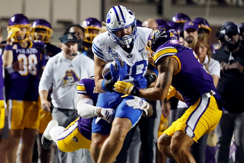 BYU tight end Carsen Ryan, front left, prepares to be hit by East Carolina's Teagan Wilk, front right, was called for targeting and ejected during the first half of an NCAA college football game in Greenville, N.C., Saturday, Sept. 20, 2025.