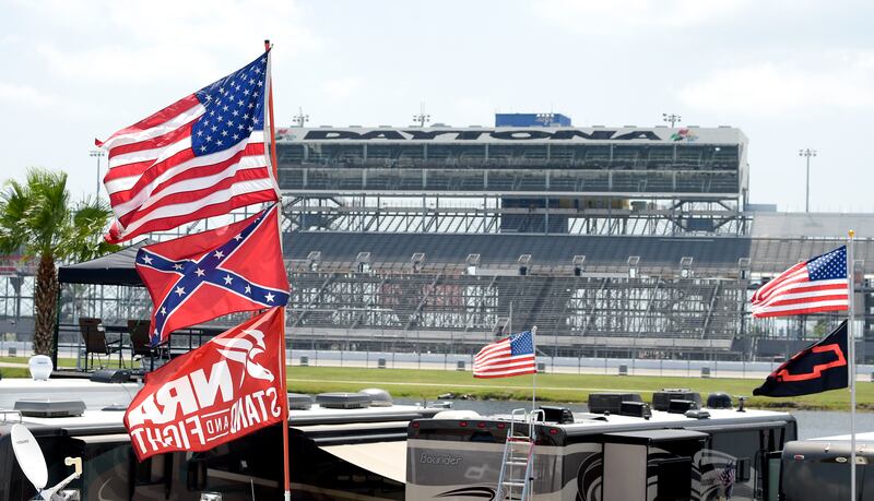 In this July 4, 2015, file photo, confederate and American flags fly on top of motor homes at Daytona International Speedway in Daytona Beach, Fla.