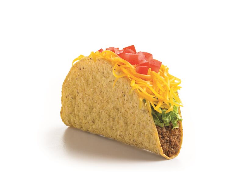 A beef taco from Del Taco with cheese, lettuce and salsa.