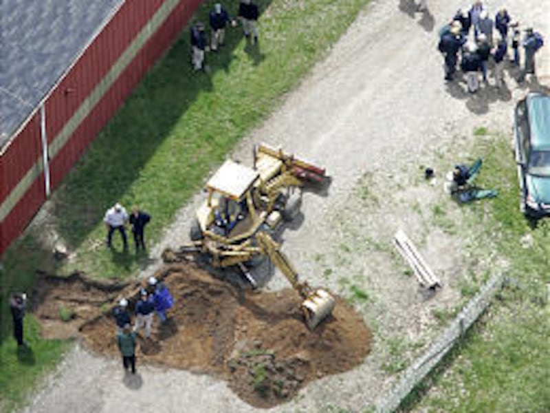 Workers using shovels and heavy equipment dig near a barn at a horse farm near Detroit Thursday as they search for the remains of former Teamsters leader Jimmy Hoffa, who disappeared in 1975. The farm was once owned by a Hoffa associate.