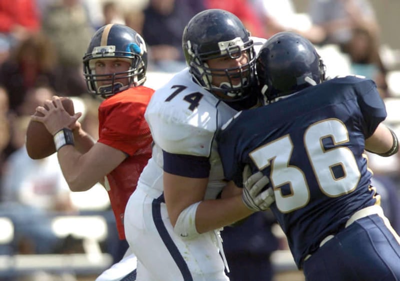 Quarterback Jackson Brown (17) drops back for a pass as Nick Longshore (74) keeps Markell Staffieri (36) at bay during the annual BYU Blue & White game at LaVell Edwards Stadium in Provo Saturday, April 10, 2004. Photo by Jason Olson