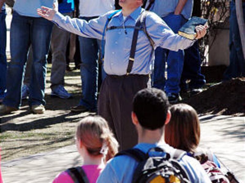 Micah Armstrong, center, known as Brother Micah on college campuses across the eastern United States, preaches to students at the University of Alabama in Tuscaloosa, Ala., in March.
