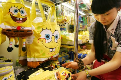 Kiddy Land toy store salesclerk Juri Igarashi arranges SpongeBob goods in Tokyo Tuesday, Dec. 5, 2006. In Japan, more than 30 companies are churning out goods plastered with SpongeBob's likeness, including everything from a 200 yen ($1.70) eraser to a 37,