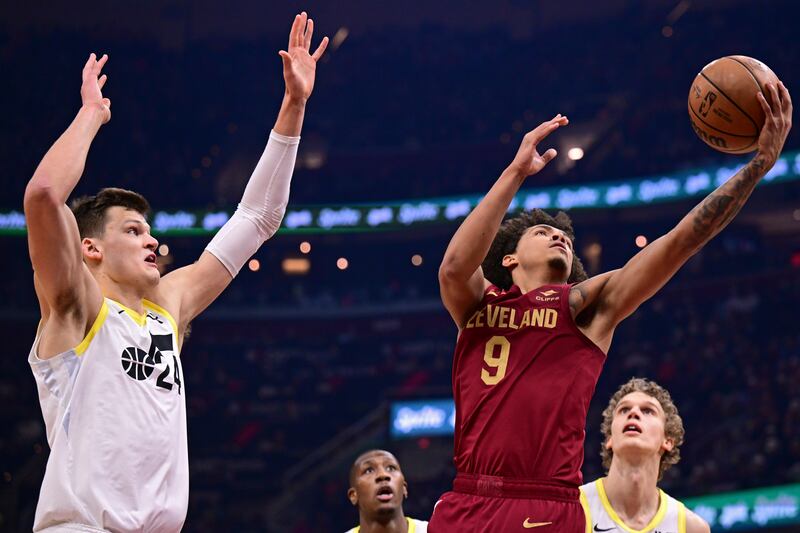 Cleveland Cavaliers guard Craig Porter goes to the basket against Utah Jazz center Walker Kessler during the first half of an NBA basketball game Wednesday, Dec. 20, 2023, in Cleveland. (AP Photo/David Dermer)
