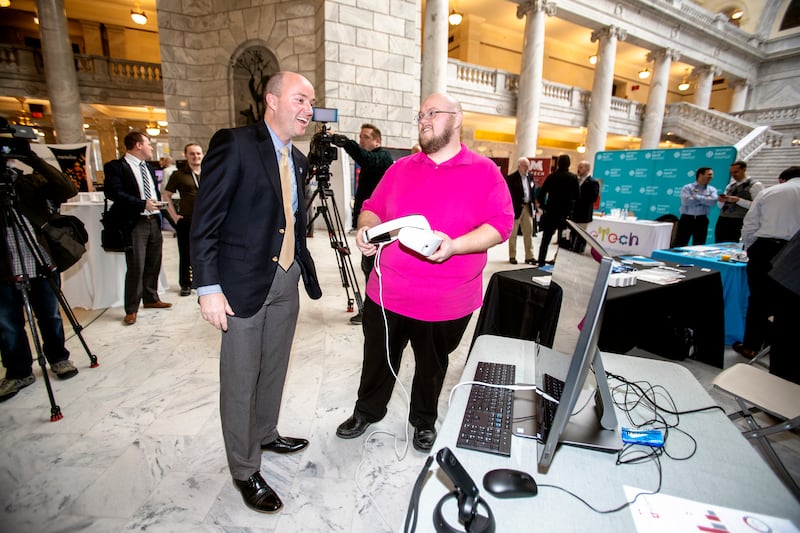 Kim Sundquist with Dell talks with Utah Lt. Gov.Spencer Cox prior to showing a virtual reality game during Tech Day on the Hill at the state Capitol in Salt Lake City on Monday, Feb. 25, 2019.