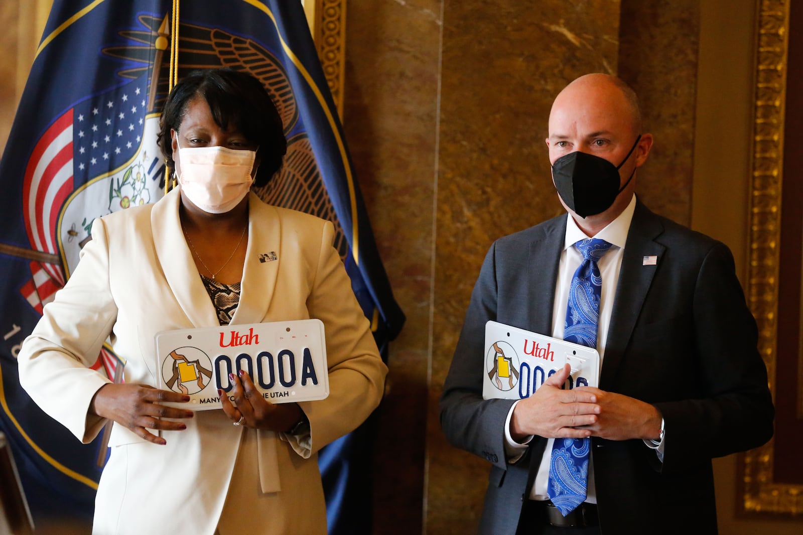 Rep. Sandra Hollins, D-Salt Lake City, left, and Gov. Spencer Cox participate in the launch of new Utah license plate.