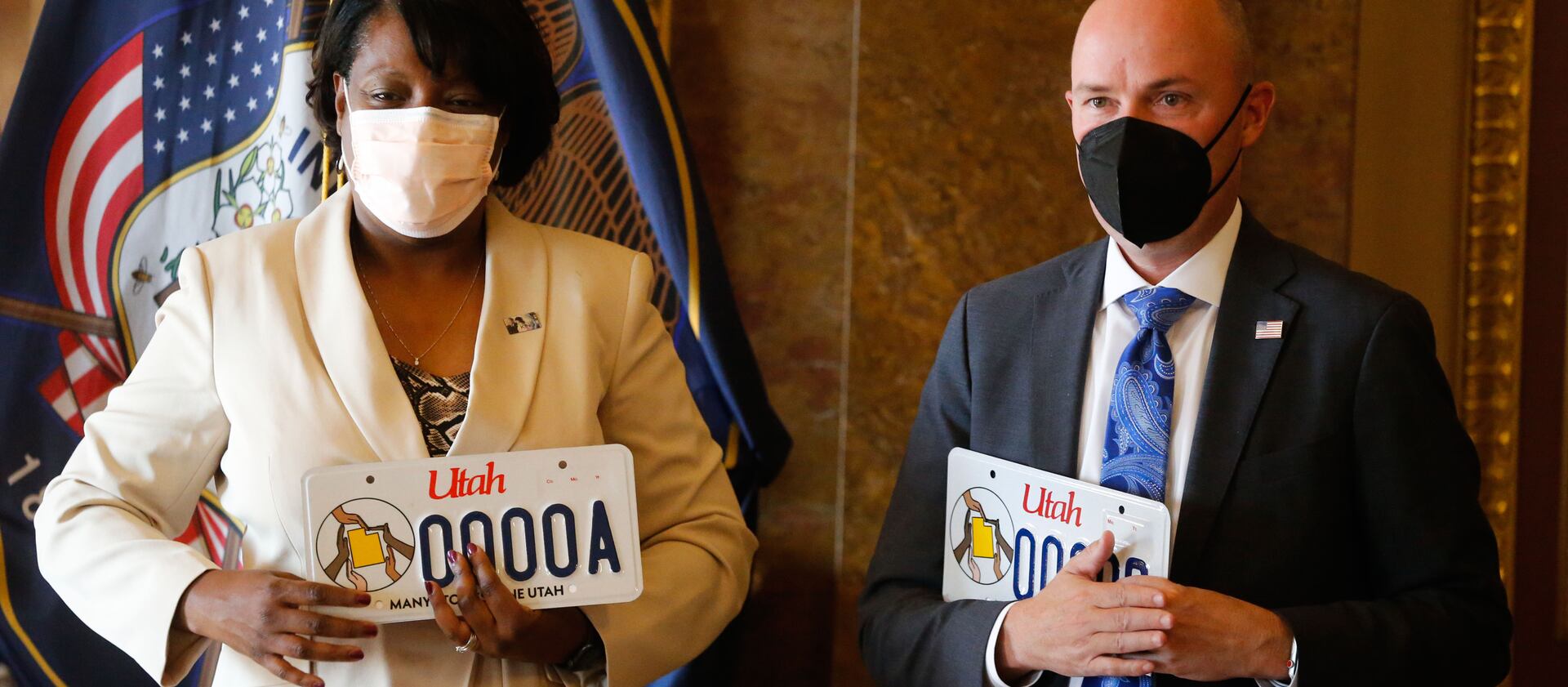 Rep. Sandra Hollins, D-Salt Lake City, left, and Gov. Spencer Cox participate in the launch of new Utah license plate.