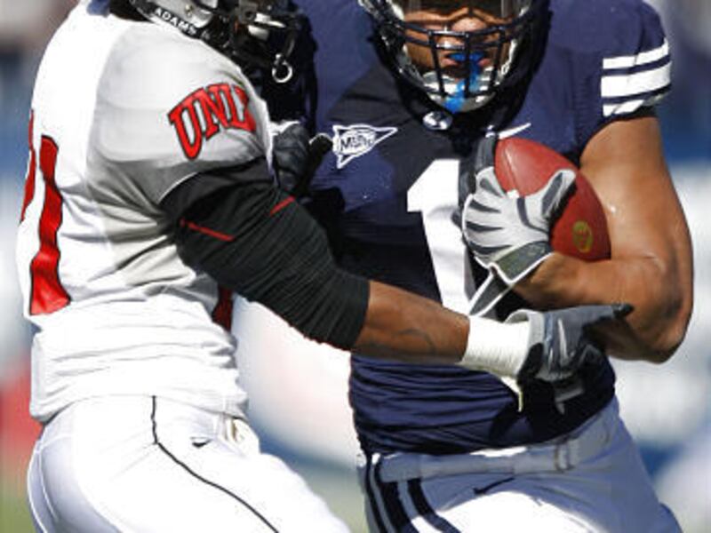 BYU's Fui Vakapuna powers past UNLV's Lorenzo Bursey Jr. en route to 72 yards on just nine carries in the Cougars' 42-35 win.