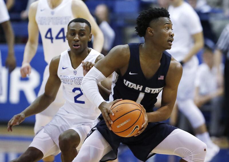 Utah State guard Koby McEwen, right, looks to pass the ball as Air Force guard CJ Siples defends in the second half of an NCAA college basketball game Saturday, Feb. 24, 2018, at Air Force Academy, Colo. (AP Photo/David Zalubowski)