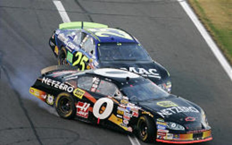 Brian Vickers (25) bumps Mike Bliss (0) near the finish line during the NASCAR Nextel Open. Vickers then went right around Bliss to win.