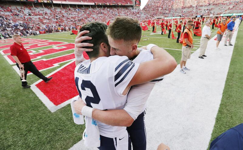Brigham Young Cougars quarterback Tanner Mangum (12) and Brigham Young Cougars wide receiver Mitch Mathews (10) embrace after beating Nebraska in Lincoln, Nebraska, Saturday, Sept. 5, 2015. BYU won 33-28 on a Hail Mary throw from Mangum to Matthews.