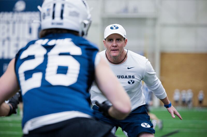 BYU defensive coordinator Jay Hill gets hands-on during spring practice at the Cougars Indoor Practice Facility in Provo.