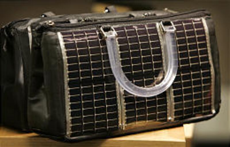 A solar purse designed by Iowa State doctoral student Joe Hynek can power a cell phone.