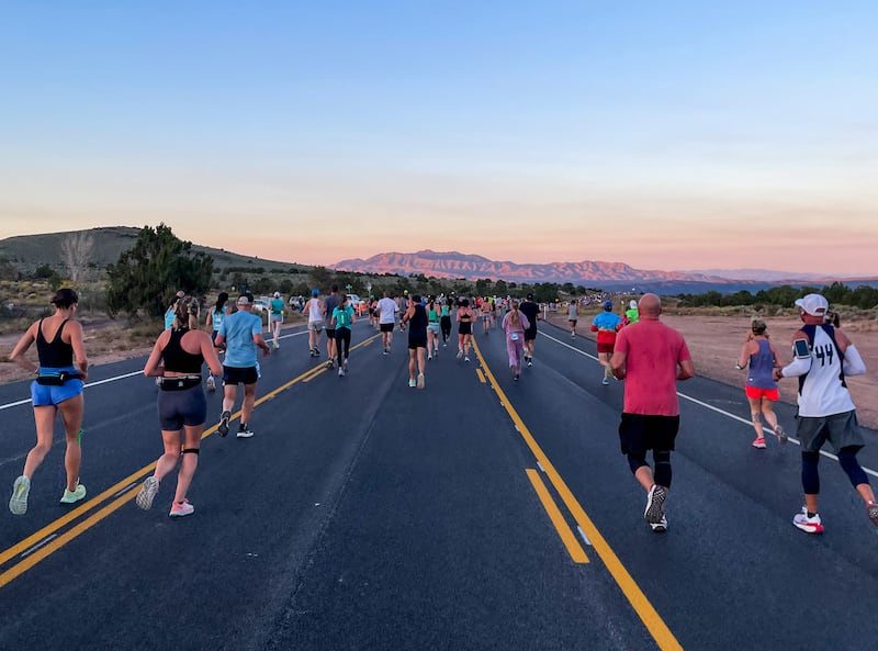 The sun rises as runners take part in the St. George Marathon on Saturday, Oct. 7, 2023.