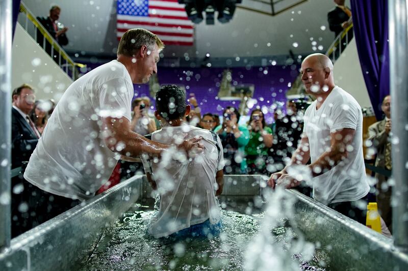 Jesse Taylor, left, and Corey Van Buren, right, assist with baptisms at the Jehovah's Witnesses convention at the Dee Events Center in Ogden on Saturday, July 6, 2019.