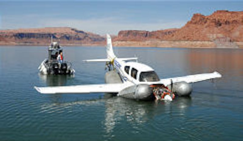 The plane that was carrying Olympic medalist Rulon Gardner is raised from Lake Powell. The pilot reportedly lost his depth perception.