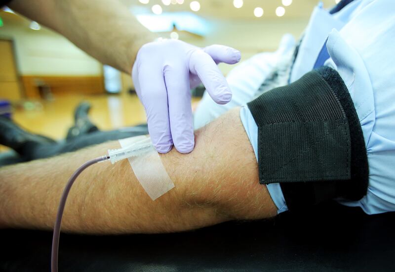 American Red Cross phlebotomist Alex White holds a needle in Brock Liston’s arm steady as Liston donates blood at Salt Lake Community College in Taylorsville on Tuesday, June 11, 2019.