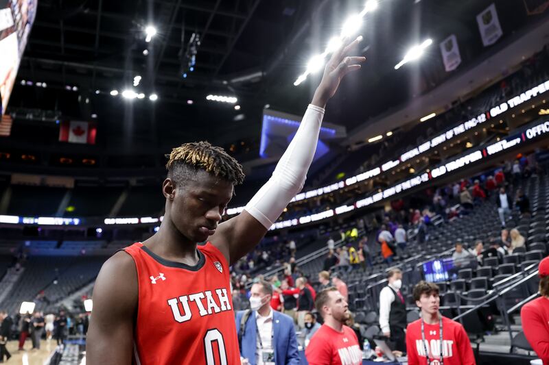 Utah Utes center Lahat Thioune (0) acknowledges fans as he leaves the court after his team’s loss to the Washington Huskies in a first-round Pac-12 tournament game at T-Mobile Arena in Las Vegas on Wednesday, March 9, 2022.