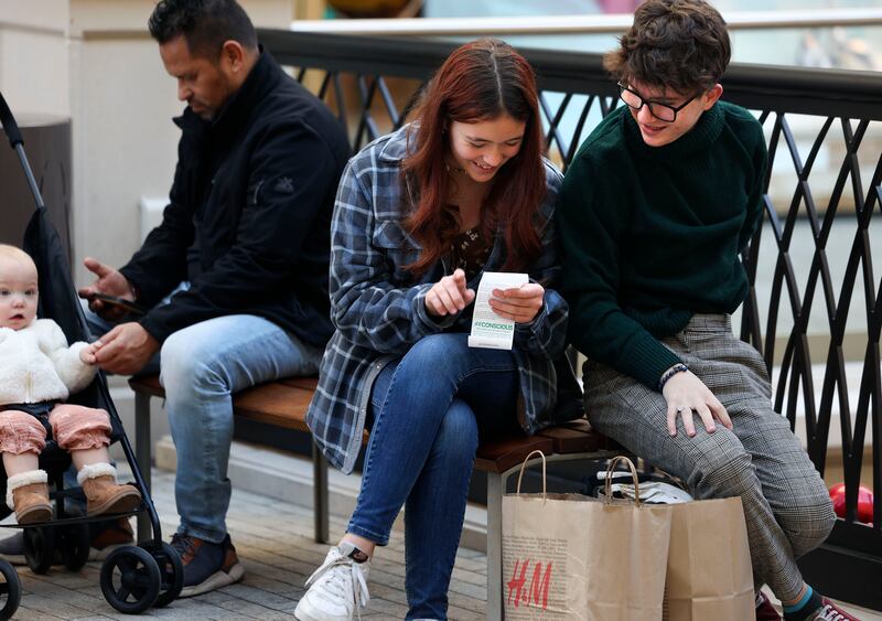 Abbie Webster and Sean Hammond look over Webster’s receipt after shopping at H&M at the City Creek Center in Salt Lake City on Nov. 25, 2022.