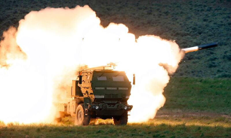 A launch truck fires the High Mobility Artillery Rocket System (HIMARS) produced by Lockheed Martin during combat training in the high desert of the Yakima Training Center, Wash.