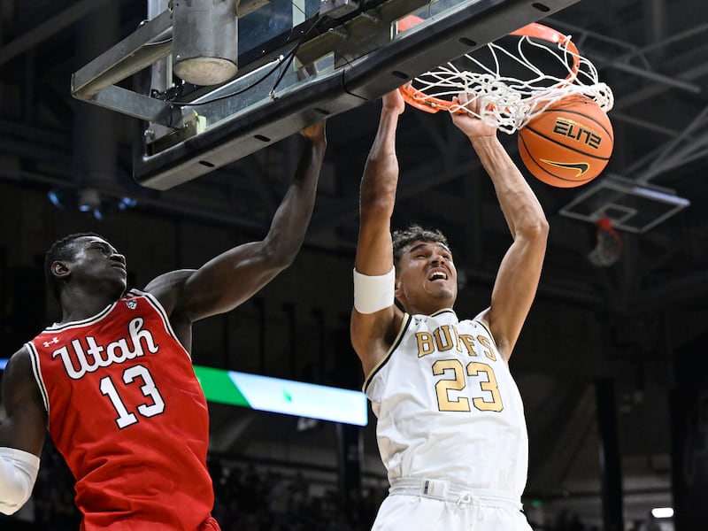 Colorado forward Tristan da Silva (23) dunks as Utah center Keba Keita (13) defends in the first half of an NCAA college basketball game Saturday, Feb. 24, 2024, in Boulder, Colo.