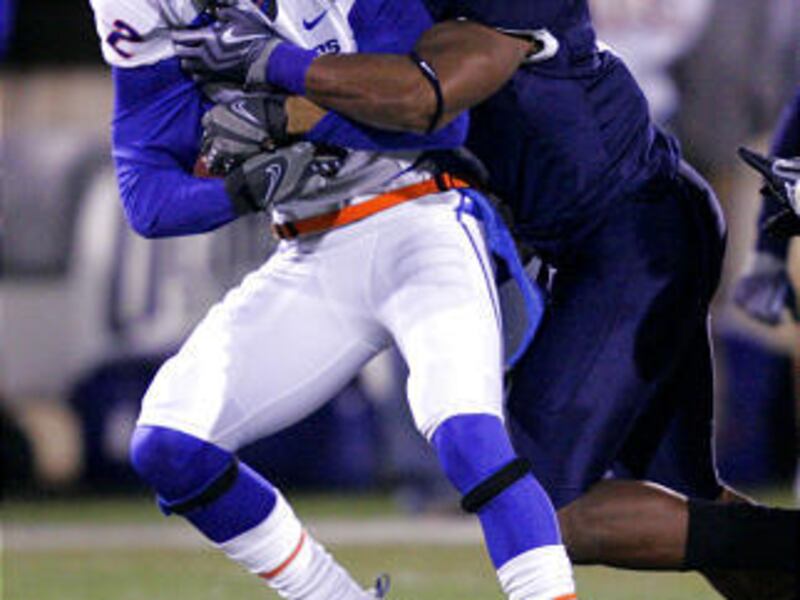 Boise State running back Doug Martin (22) is tackled by Utah State linebacker Bobby Wagner (9) at Romney Stadium in Logan Friday.