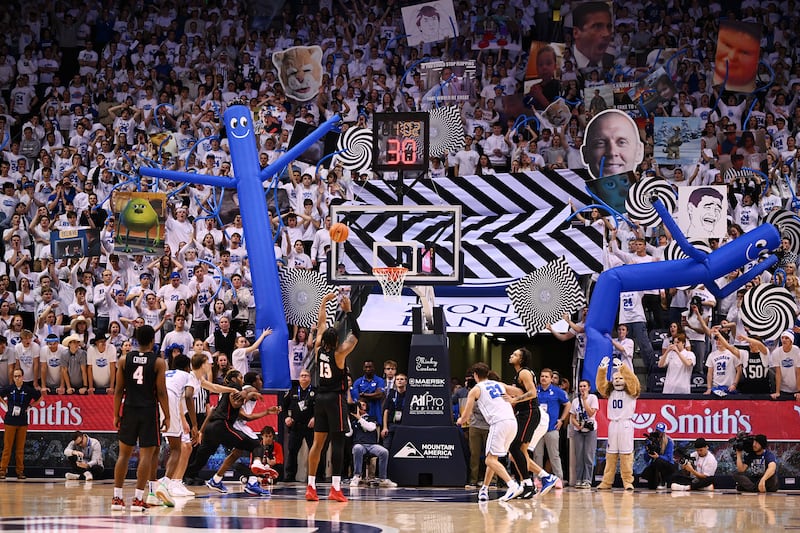 BYU students try to disrupt Houston Cougars forward J’Wan Roberts as he shoots a free throw at the Marriott Center in Provo.