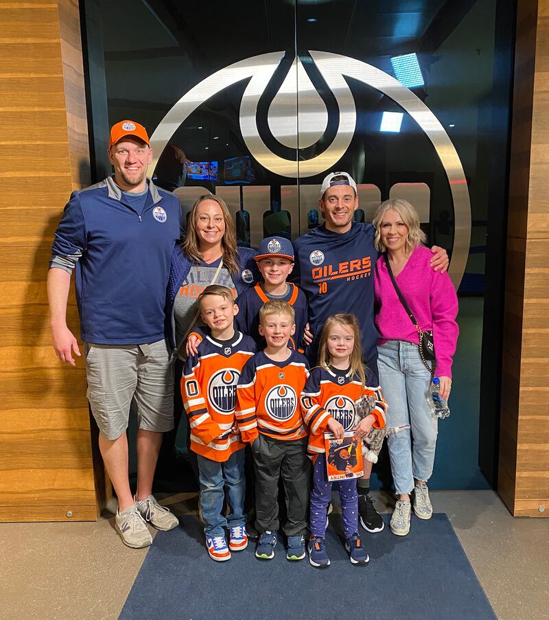 Edmonton’s Derek Ryan stands for a photo with family members after the Oiler’s series victory over Calgary.