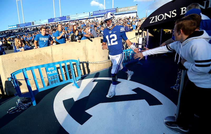 Brigham Young Cougars quarterback Tanner Mangum (12) talks the field prior to the Cougars game against Utah State at LaVell Edwards Stadium in Provo on Friday, Oct. 5, 2018.