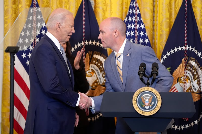 Utah Gov. Spencer Cox, right, greets President Joe Biden in the East Room of the White House on Feb. 23, 2024, in Washington.