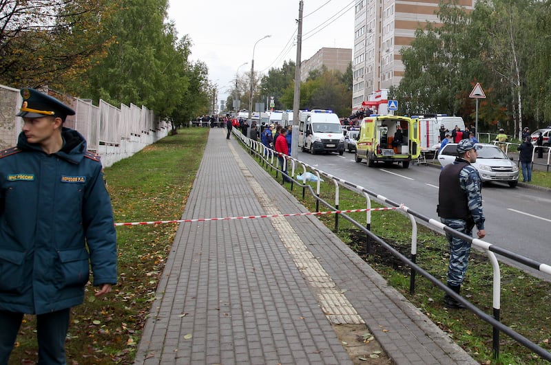 Police block an area as investigators and paramedics work at the scene of a shooting at school No. 88 in Izhevsk, Russia.