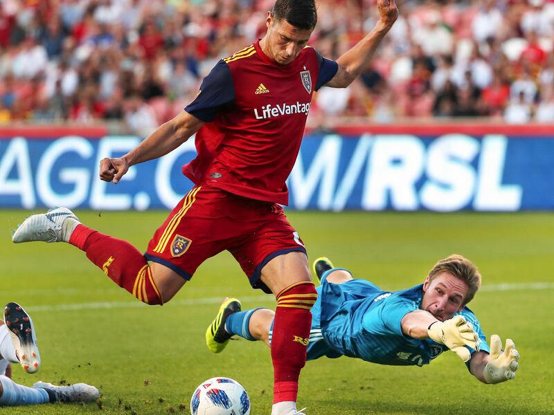 Real Salt Lake midfielder Damir Kreilach (6) fires a shot past diving Sporting Kansas City goalkeeper Tim Melia (29)during the Real Salt Lake versus Sporting KC at Rio Tinto Stadium in Sandy on Wednesday, July 4, 2018. Kreilach's (6) shot just missed.