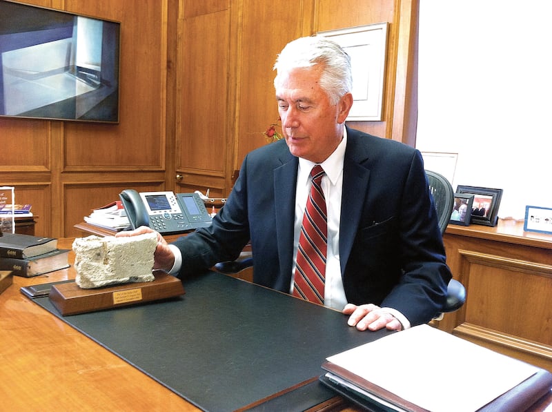 Elder Dieter F. Uchtdorf looks at a piece of the Berlin Wall.