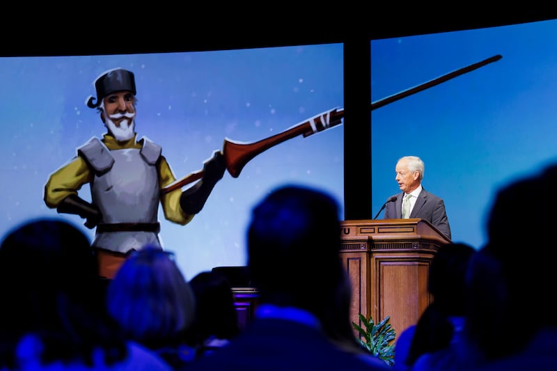 An image of Don Quixote is shown as Elder Michael A. Dunn delivers a BYU devotional on March 4, 2025.